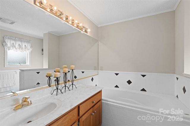 full bath featuring visible vents, vanity, a garden tub, and ornamental molding