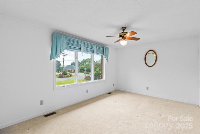 spare room with visible vents, light carpet, and baseboards