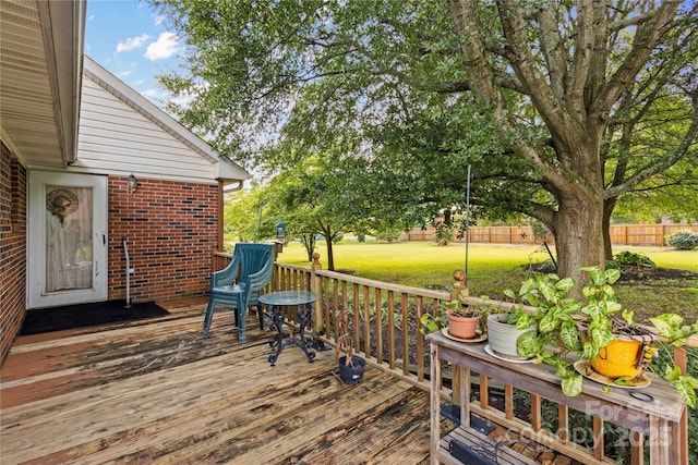 deck featuring a yard and fence