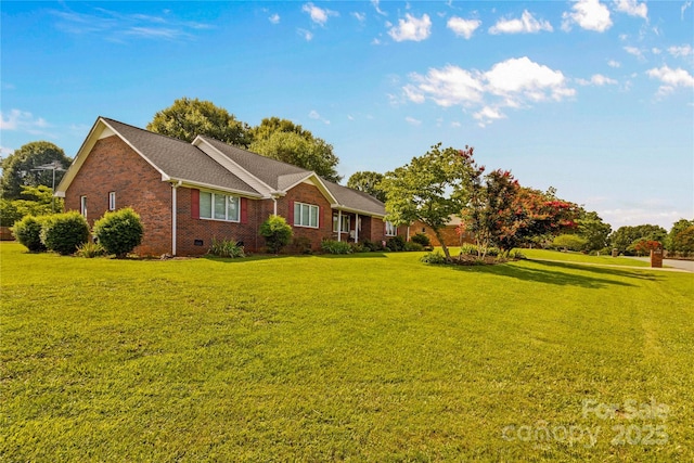 ranch-style home with a front yard, brick siding, and crawl space