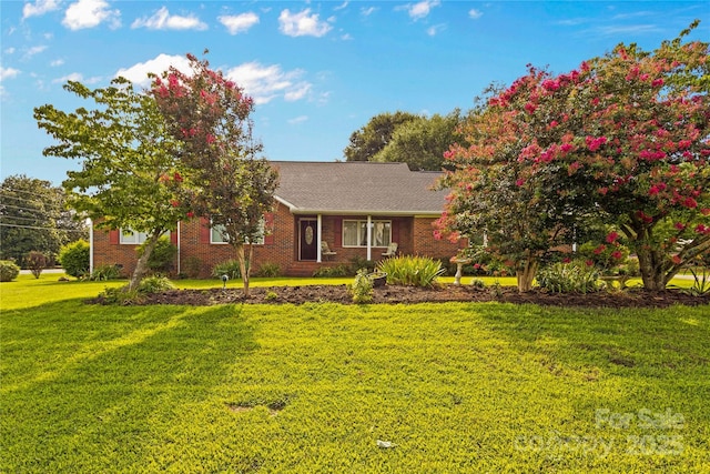 ranch-style home with brick siding and a front lawn