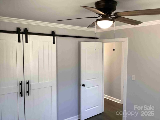 unfurnished bedroom featuring ceiling fan, baseboards, dark wood-style flooring, and ornamental molding