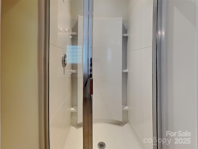 full bath with a shower stall