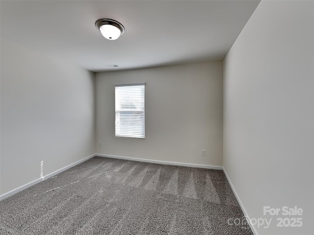 carpeted spare room with baseboards