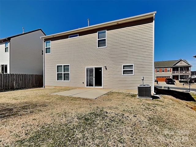 back of property featuring a patio area, central air condition unit, a yard, and fence