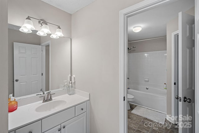 full bath with vanity, toilet, bathtub / shower combination, and a textured ceiling