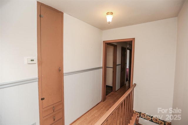 hallway featuring a wainscoted wall