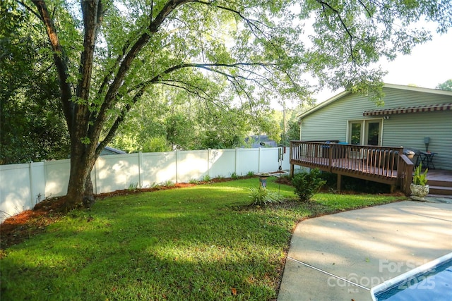 view of yard featuring a fenced backyard and a deck