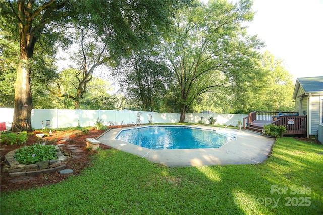 view of pool featuring a yard, a fenced in pool, a wooden deck, and a fenced backyard