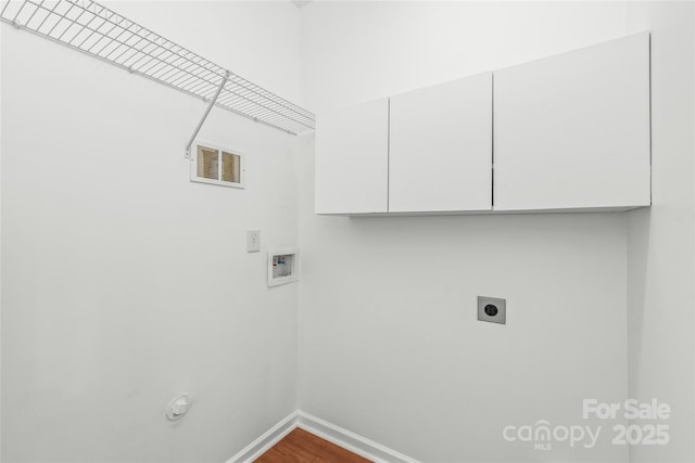 laundry area with electric dryer hookup, visible vents, washer hookup, cabinet space, and baseboards