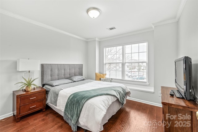 bedroom with visible vents, crown molding, baseboards, and dark wood-style flooring