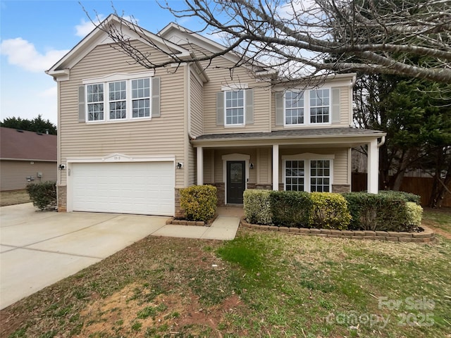 traditional-style home featuring an attached garage and driveway