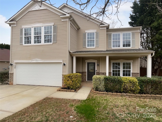 view of front facade featuring stone siding, an attached garage, and concrete driveway