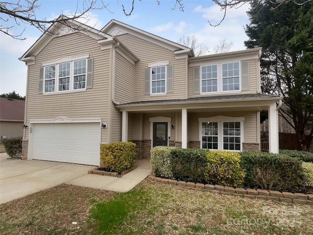 traditional-style house featuring a garage and driveway