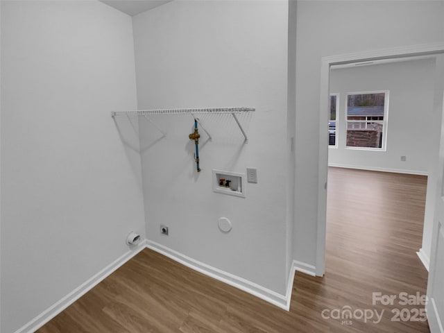 laundry room featuring baseboards, gas dryer hookup, washer hookup, laundry area, and wood finished floors