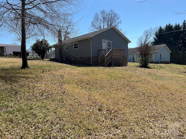 back of property with crawl space and a lawn