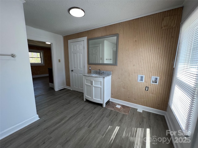 washroom featuring dark wood-type flooring, washer hookup, a sink, a textured ceiling, and laundry area