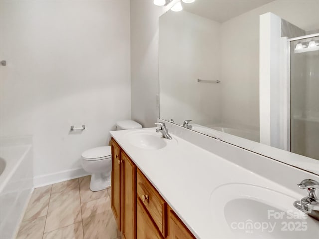 bathroom featuring a sink, a shower with door, toilet, and double vanity