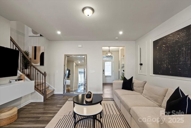 living room featuring dark wood finished floors, stairway, recessed lighting, and baseboards