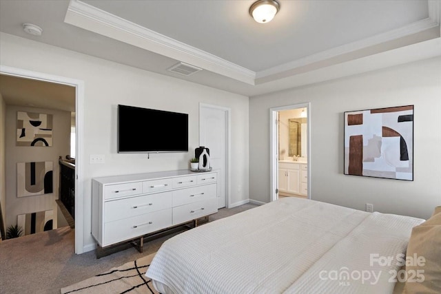 bedroom featuring visible vents, a raised ceiling, light colored carpet, and ornamental molding