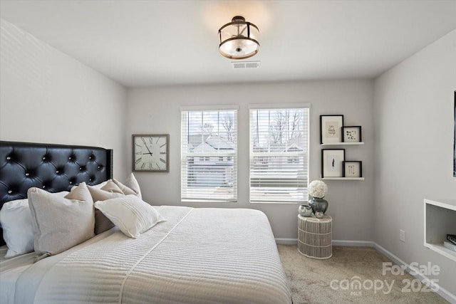 bedroom with visible vents, carpet floors, and baseboards