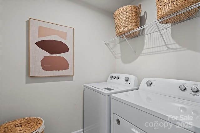 washroom with separate washer and dryer and laundry area