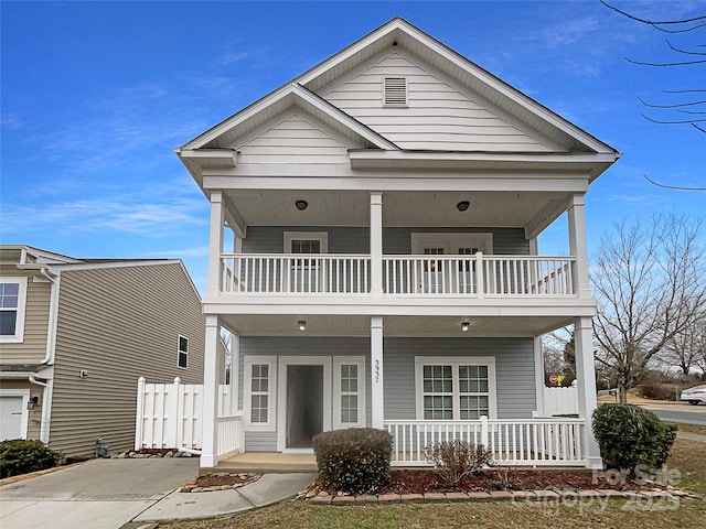 view of front of property featuring a balcony and a porch