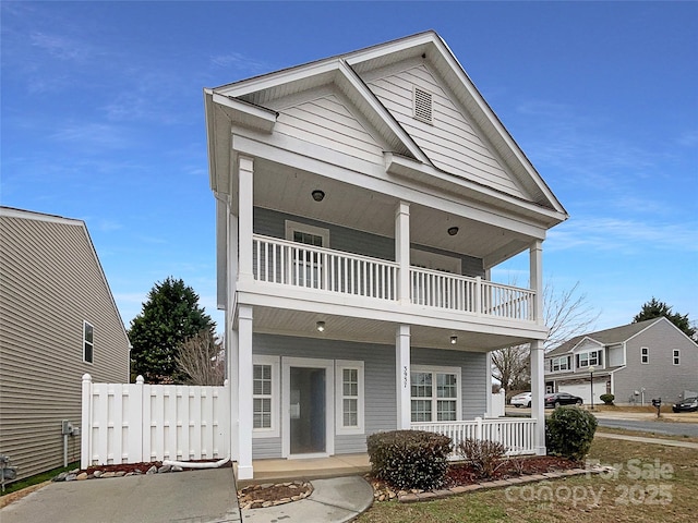 view of front of property with a balcony and covered porch