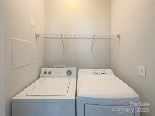 clothes washing area with laundry area and independent washer and dryer