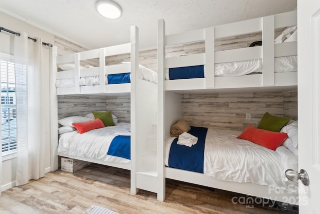 bedroom with wood finished floors and a textured ceiling