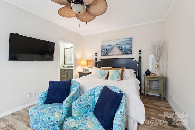 bedroom with baseboards, wood finished floors, and ornamental molding