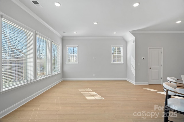 empty room with visible vents, baseboards, ornamental molding, recessed lighting, and light wood-style floors