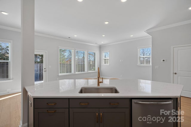 kitchen with light wood finished floors, dishwasher, light stone counters, plenty of natural light, and a sink