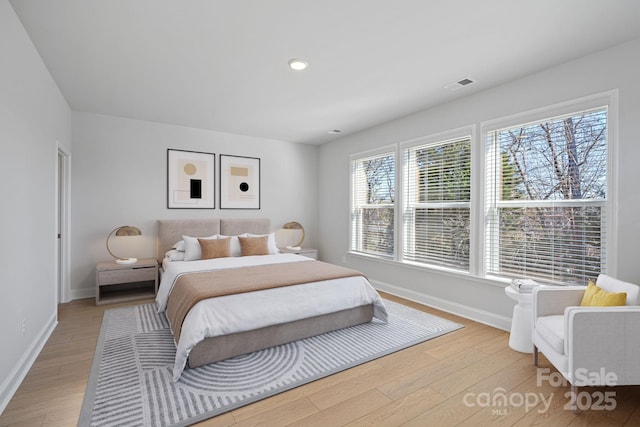 bedroom with recessed lighting, visible vents, baseboards, and light wood finished floors