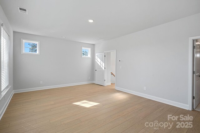 interior space with visible vents, light wood-type flooring, and baseboards