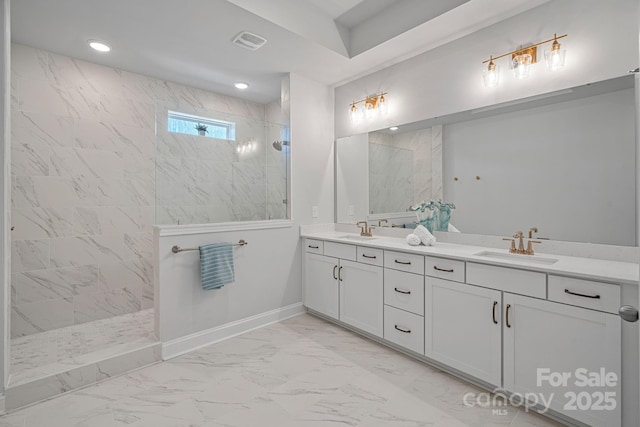 bathroom featuring a sink, visible vents, marble finish floor, and a walk in shower