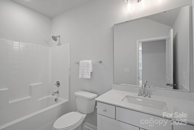 bathroom with vanity, toilet, and shower / tub combination