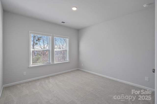 carpeted empty room featuring recessed lighting, baseboards, and visible vents