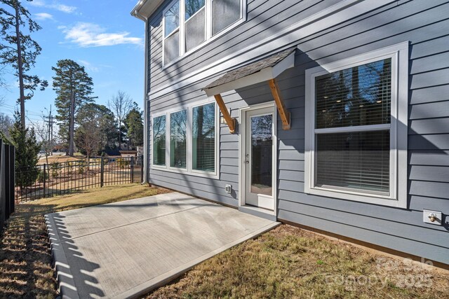 property entrance with a patio area and fence