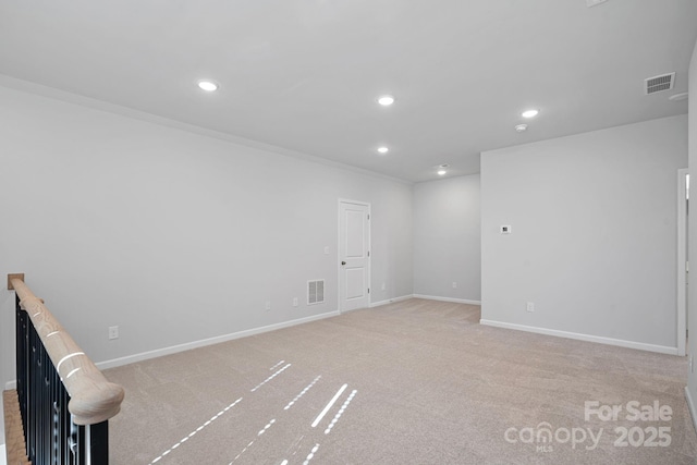 spare room featuring recessed lighting, visible vents, carpet floors, and baseboards