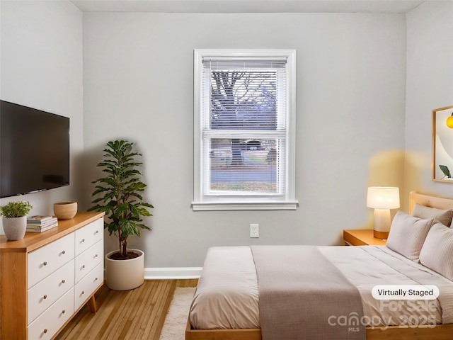 bedroom featuring light wood-type flooring and baseboards