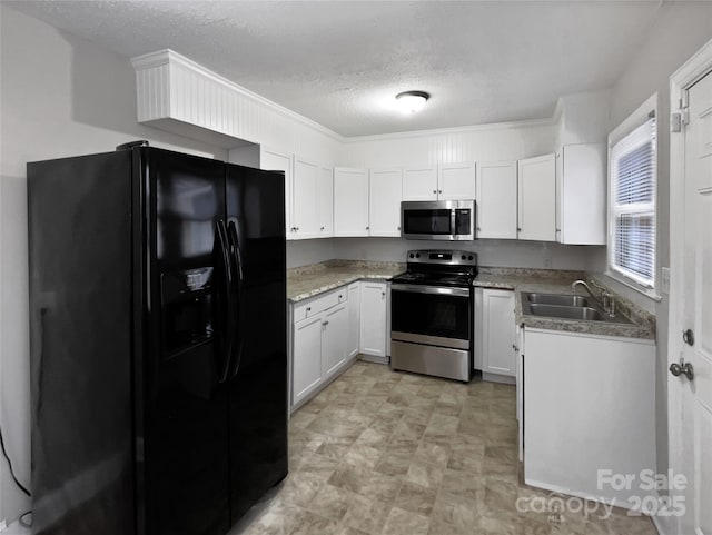 kitchen featuring a sink, a textured ceiling, white cabinets, and stainless steel appliances