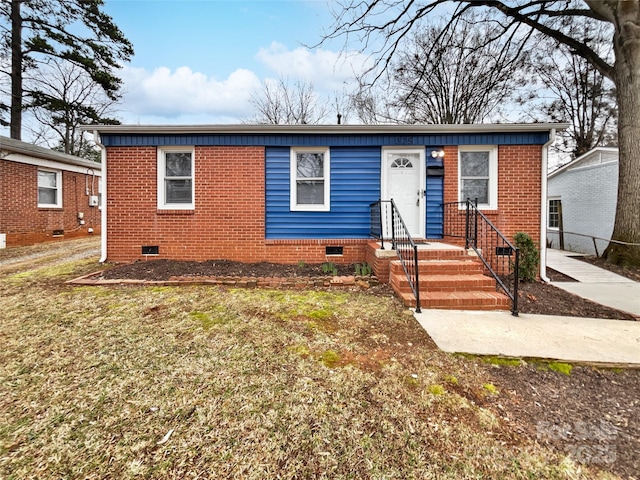 bungalow featuring crawl space and brick siding