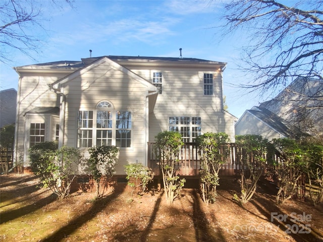 rear view of property featuring a deck