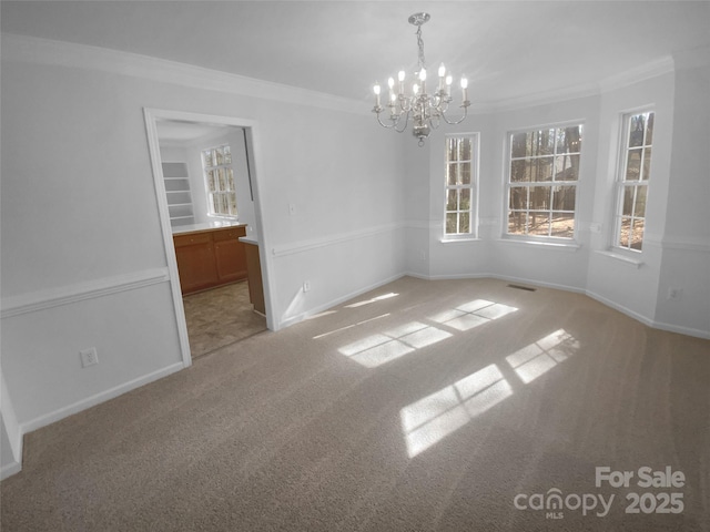 unfurnished dining area with crown molding, a notable chandelier, visible vents, and light carpet