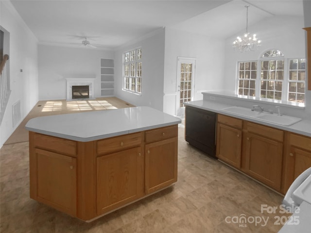 kitchen with open floor plan, light countertops, black dishwasher, a premium fireplace, and a sink