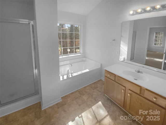 full bath featuring a shower stall, vanity, and a garden tub