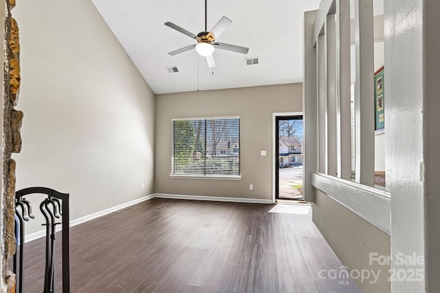 unfurnished room featuring ceiling fan, visible vents, a textured ceiling, and wood finished floors