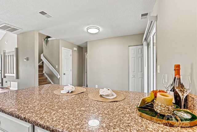 kitchen featuring visible vents and a textured ceiling