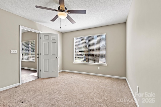 unfurnished bedroom featuring baseboards, carpet floors, a textured ceiling, and ceiling fan